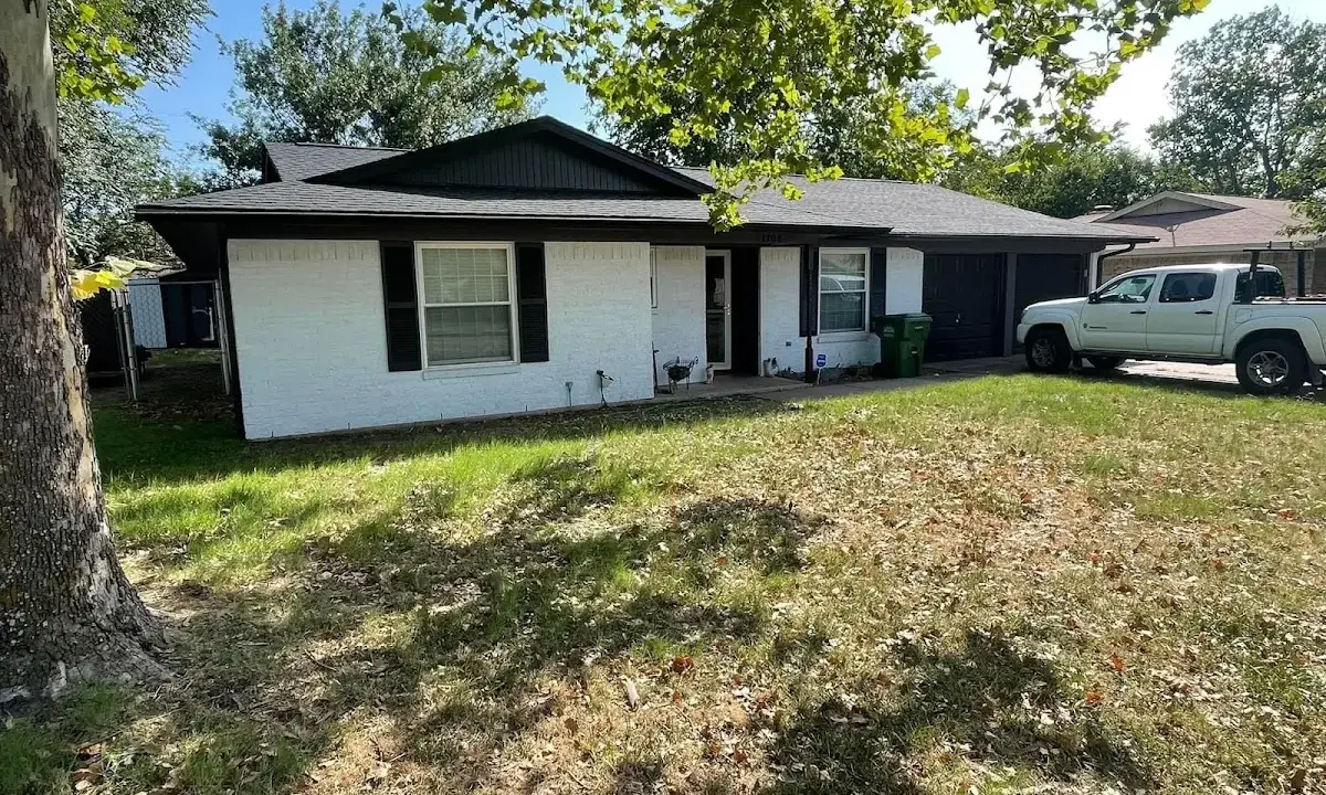 Professional roofing crew working on a residential roof in Pelham